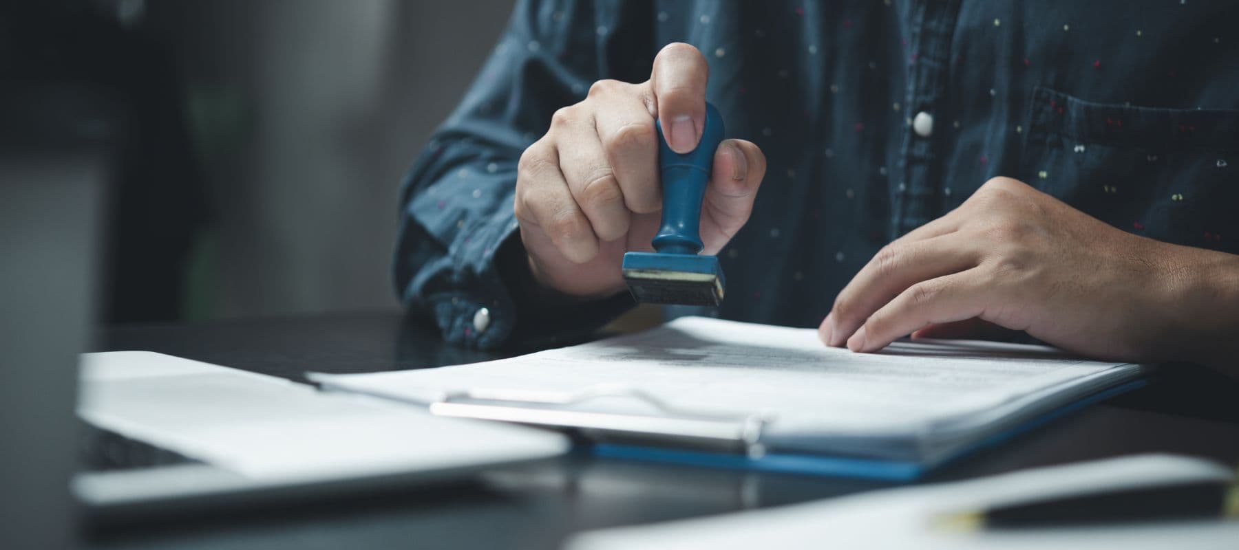 Notebook and pen with laptop open for online training